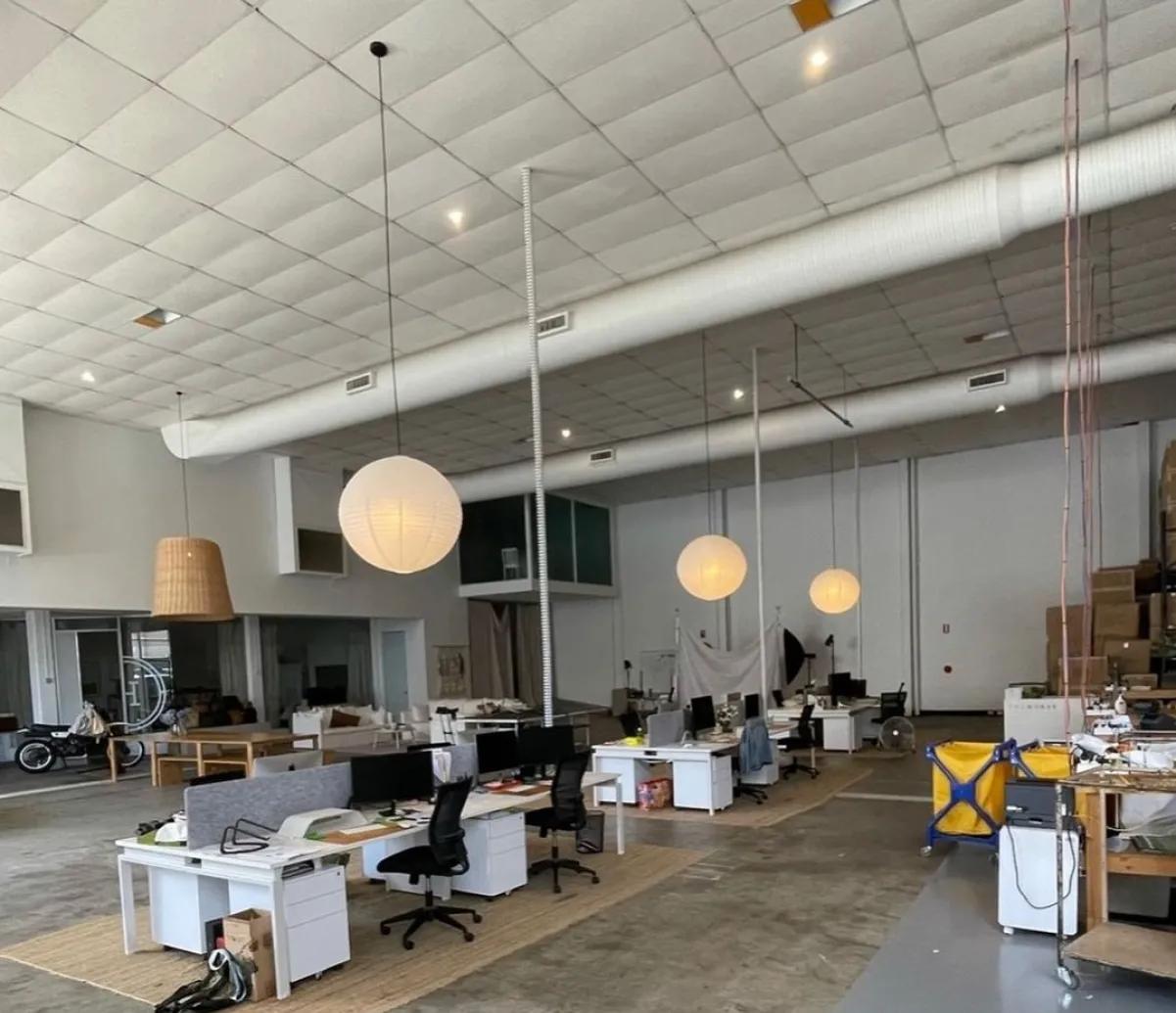 Commercial office lighting installation with pendant lights and ceiling fixtures at a workspace in Sydney